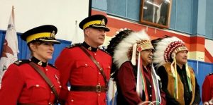 RCMP representatives stand with Grand Chief Ron Michel and Vice Chief Brian Hardlotte. Photo by Chelsea Laskowski
